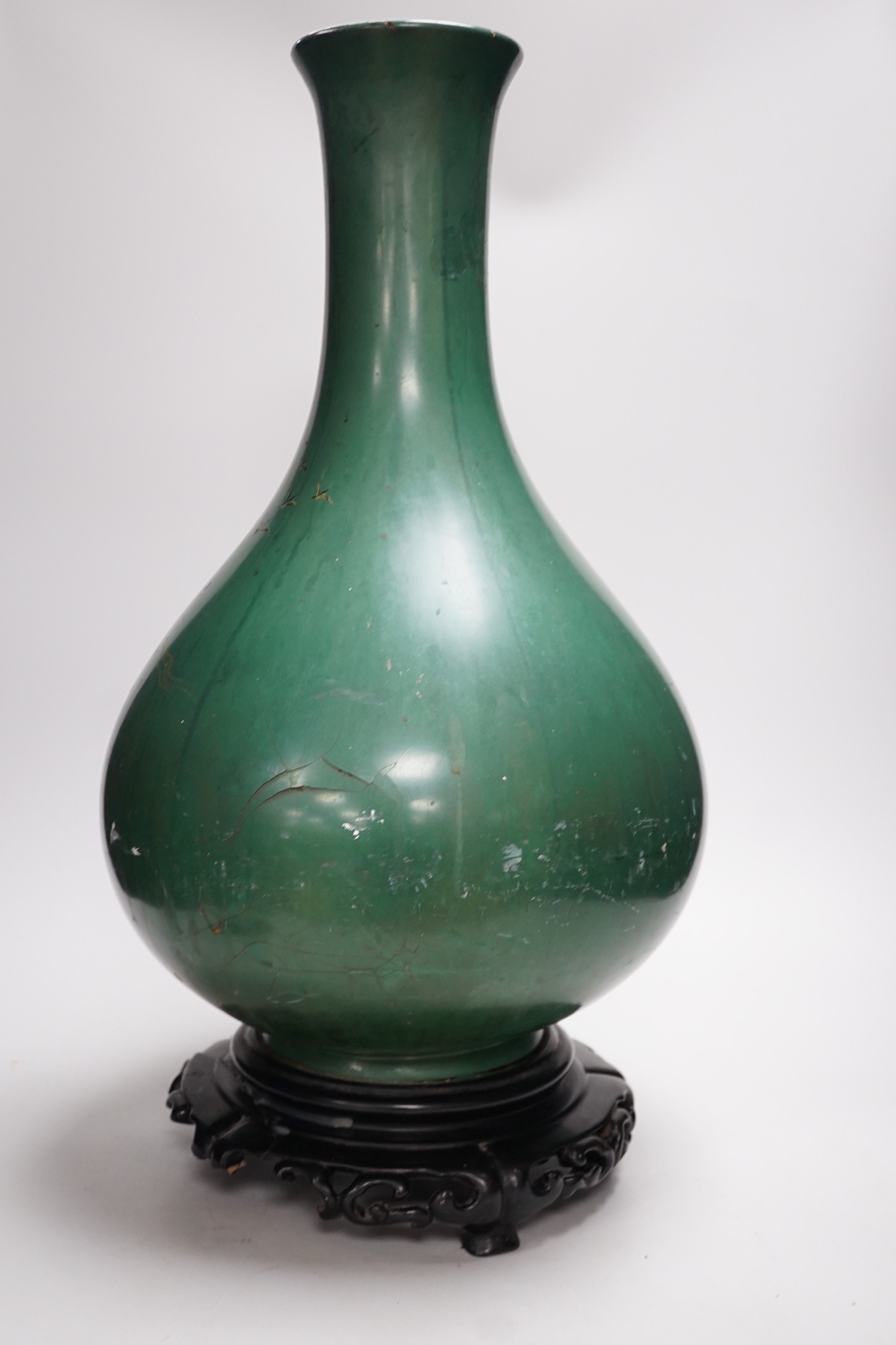 A large Chinese Fuzhou lacquer green ground vase and stand, early 20th century, 54 cm high